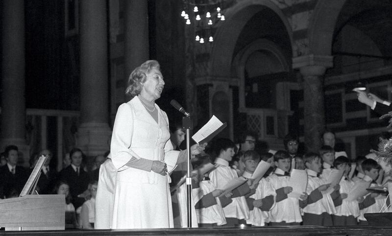 Dame Vera Lynn, accompanied by choirboys, at Westminster Abbey when she took part in the Evening News Festival of Carols.