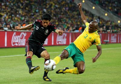 JOHANNESBURG, SOUTH AFRICA - JUNE 11: Tsepo Masilela of South Africa challenges Ricardo Osorio of Mexico during the 2010 FIFA World Cup South Africa Group A match between South Africa and Mexico at Soccer City Stadium on June 11, 2010 in Johannesburg, South Africa.  (Photo by Michael Steele/Getty Images)