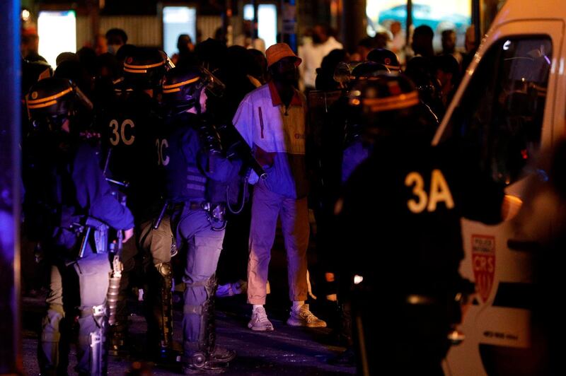 French CRS police stop protesters at Porte de Clichy. AFP