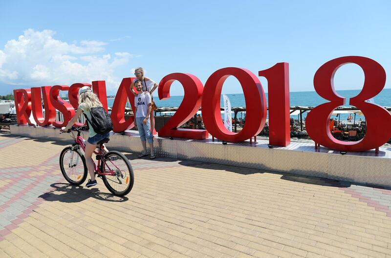 Russians pose next to a Fifa World Cup 2018 logo close to Sochi stadium in Sochi, Russia. EPA