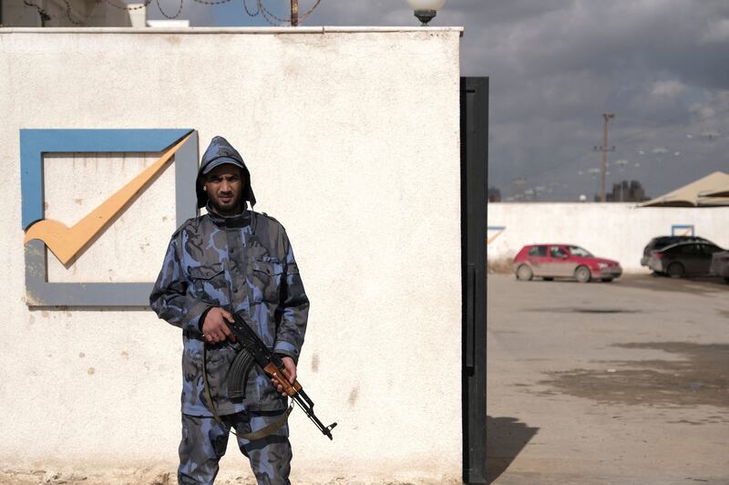 A security officer stands in front of the High National Election Commission building in Benghazi. Reuters