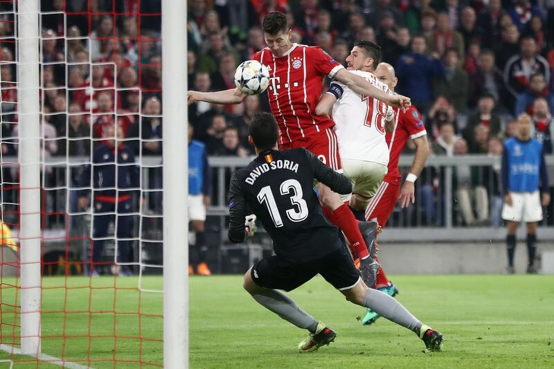 MUNICH, GERMANY - APRIL 11: Robert Lewandowski of Muenchen fails to score against goalkeeper David Soria of Sevilla during the UEFA Champions League Quarter Final Second Leg match between FC Bayern Muenchen and Sevilla FC at Allianz Arena on April 11, 2018 in Munich, Germany.  (Photo by Alex Grimm/Bongarts/Getty Images)