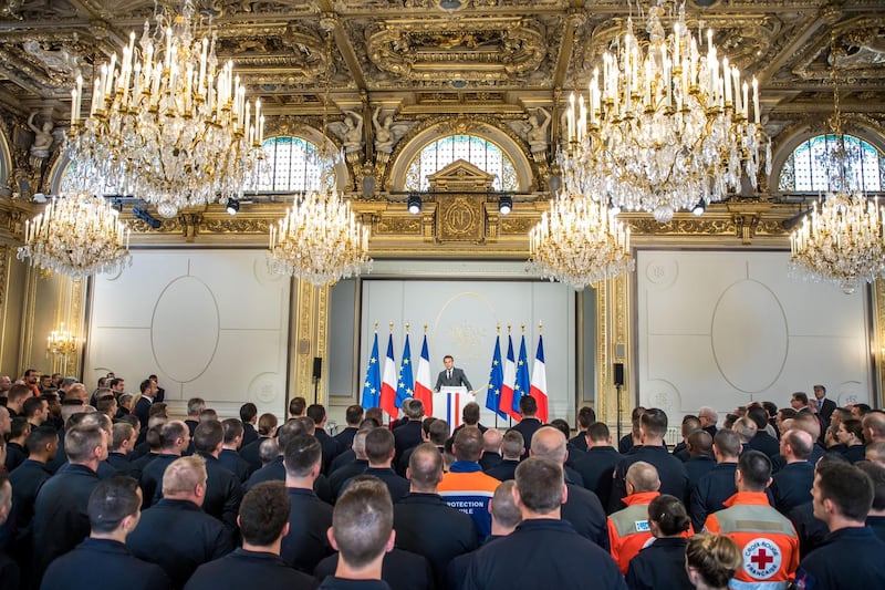 French President Emmanuel Macron delivers a speech for the Parisian Firefighters' brigade and security forces who took part at the fire extinguishing operations during the Notre Dame of Paris Cathedral fire, at Elysee Palace in Paris, France, April 18, 2019. REUTERS