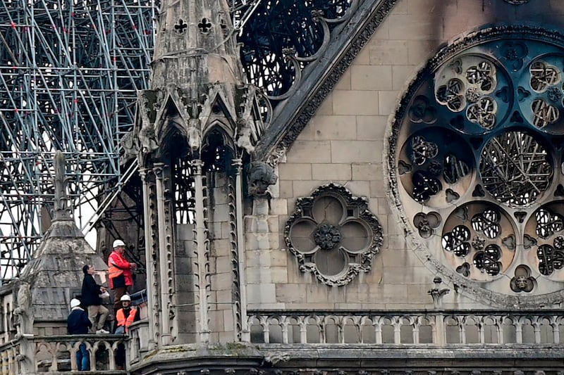 Inspectors are seen on the roof of the landmark Notre-Dame Cathedral in central Paris on April 16, 2019, the day after a fire ripped through its main roof.  AFP