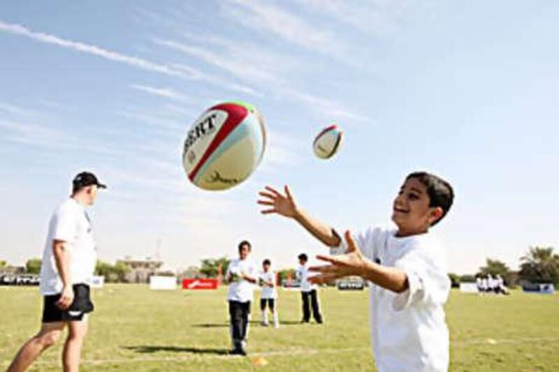 Hood Saliman Rashed, 12, throws a rugby ball during the training camp run by the Abu Dhabi Harlequins.