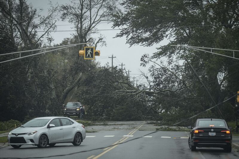 Vehicles turn around as trees and fallen power lines block a road after Fiona hit Cape Breton Island in eastern Canada. AFP