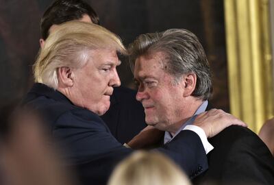 Former US President Donald Trump (left) congratulates Steve Bannon, former Senior Counselor to the President, during the swearing-in of senior staff in the White House in Washington on January 22, 2017. AFP