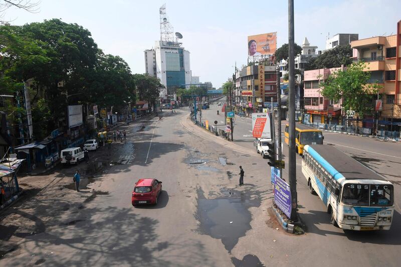 Vehicles move through a deserted road during a one-day curfew imposed as a preventive measure against coronavirus in Kolkata.  AFP