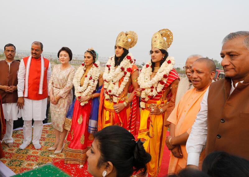 Kim Jung-Sook, third left, wife of South Korean President Moon Jae-in, poses with artists dresses as Hindu deities, garlanded from right, Lakshman, Ram and Sita during Diwali celebrations in Ayodhya, India.  The South Korean first lady is the chief guest at Diwali celebrations in Ayodhya. AP