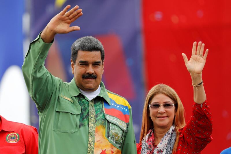 FILE PHOTO: Venezuela's President Nicolas Maduro and his wife Cilia Flores greet supporters during his closing campaign rally in Caracas, Venezuela May 17, 2018. REUTERS/Carlos Jasso/File Photo