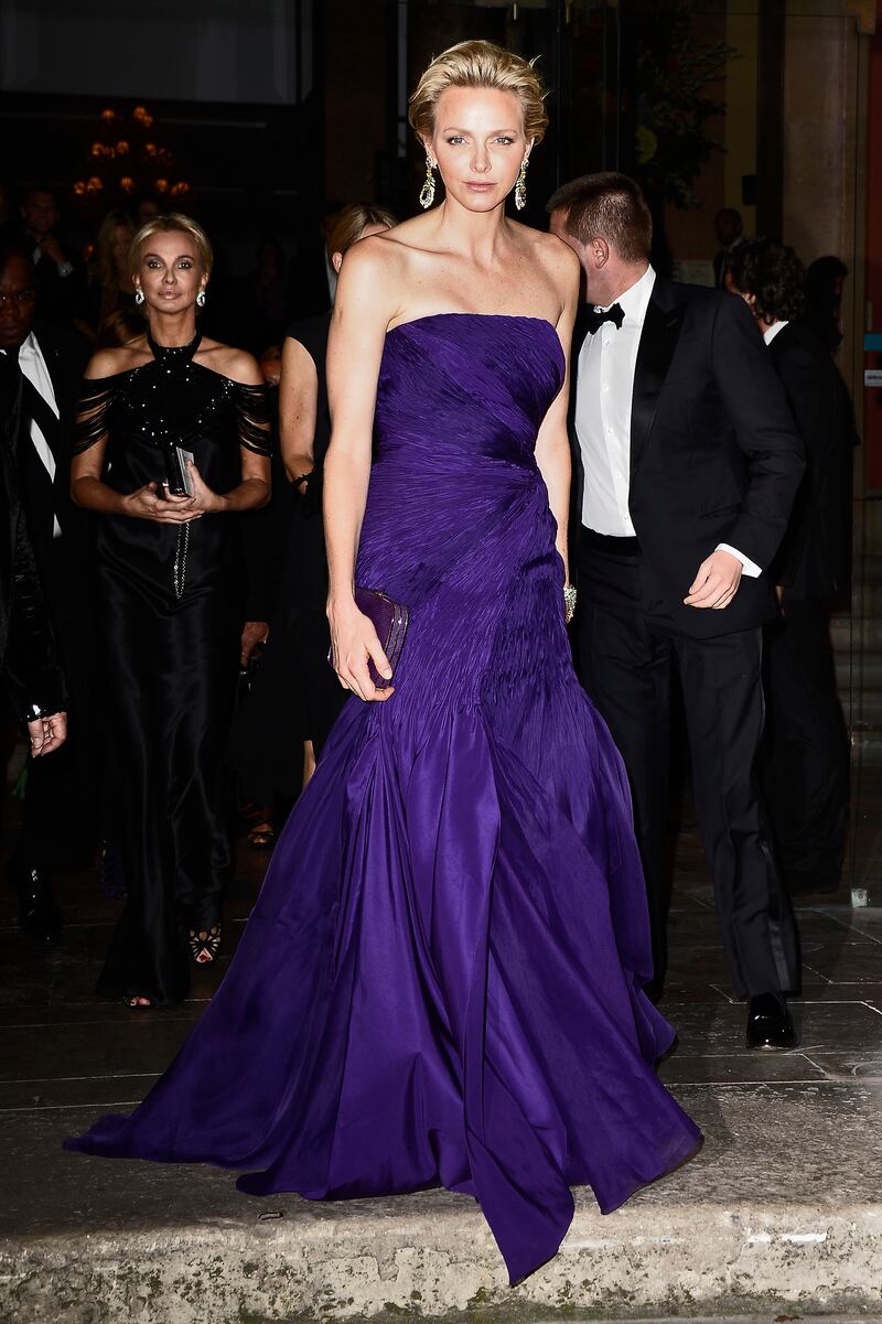 Princess Charlene, in purple Ralph Lauren, attends a Ralph Lauren Collection Show in Paris, France on October 8, 2013. Getty Images