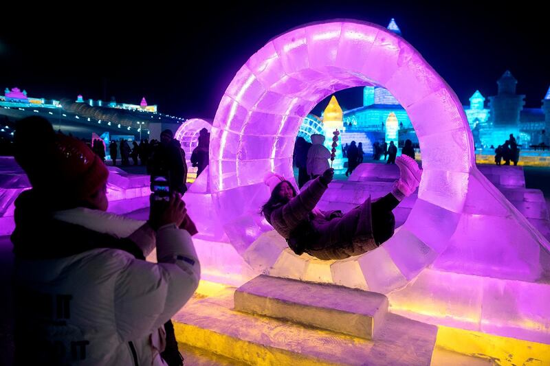 Tourists take pictures at an ice sculpture at the Harbin Ice and Snow World festival in Harbin, in China's northeast Heilongjiang province. AFP