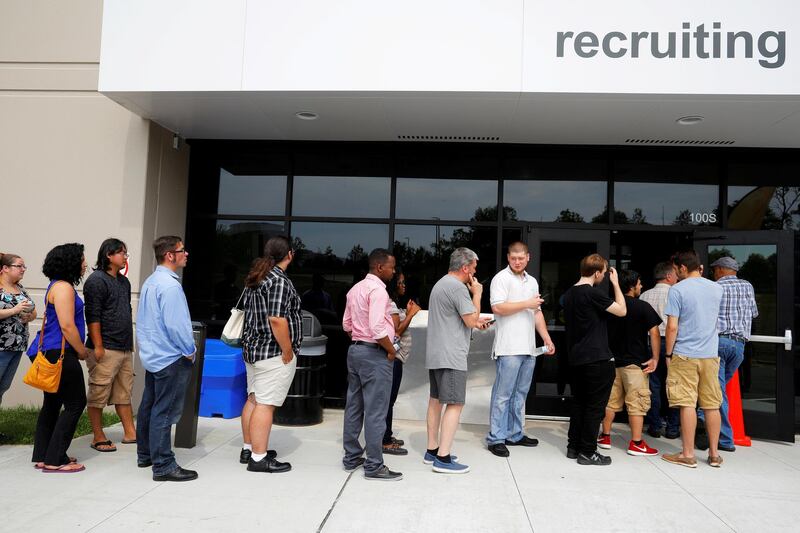 FILE PHOTO: Job seekers line up to apply during "Amazon Jobs Day," a job fair being held at 10 fulfillment centers across the United States aimed at filling more than 50,000 jobs, at the Amazon.com Fulfillment Center in Fall River, Massachusetts, U.S., August 2, 2017.   REUTERS/Brian Snyder/File Photo