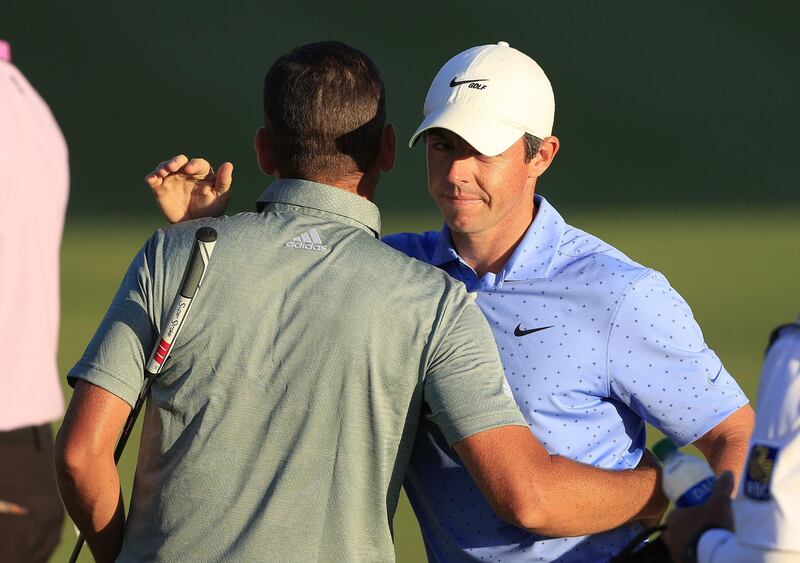 Sergio Garcia and Rory McIlroy of Northern Ireland on the 18th green. AFP