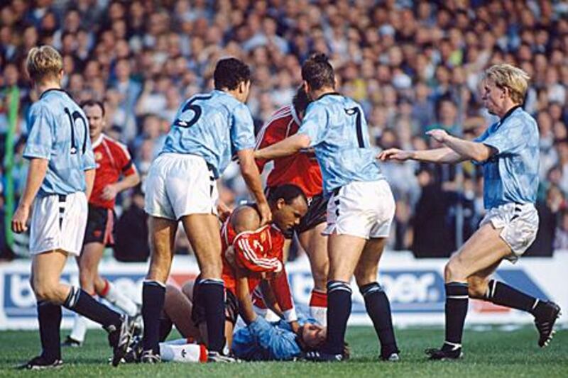 Manchester United’s Danny Wallace grabs Manchester City’s Andy Hinchcliffe around the throat as City players rush to intervene during a match at Maine Road in the 1989/90 season. City won the match 5-1, but it is United who have claimed local bragging rights in the Premier League era.