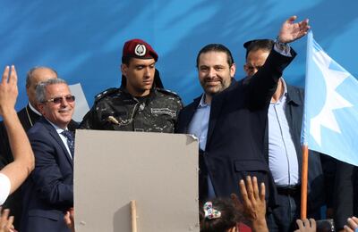 Lebanon's Prime Minister and candidate for the upcoming parliamentary elections Saad Hariri waves on stage during a campaign rally in the southern port city of Sidon on May 2, 2018. (Photo by Mahmoud ZAYYAT / AFP)