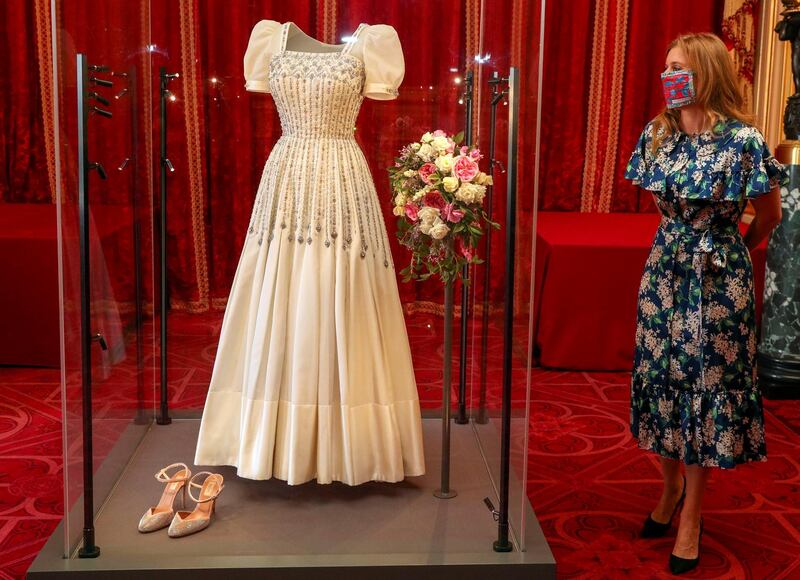 Britain's Princess Beatrice of York stands alongside her wedding dress, which was originally worn by Britain's Queen Elizabeth in the 1960s, ahead of it going on public display at Windsor Castle, Windsor, Britain, September 23, 2020. Steve Parsons/PA Wire/Pool via REUTERS