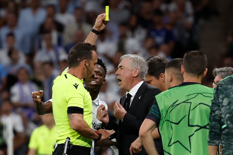 Referee Artur Dias shows a yellow card to Real Madrid coach Carlos Ancelotti . EPA 