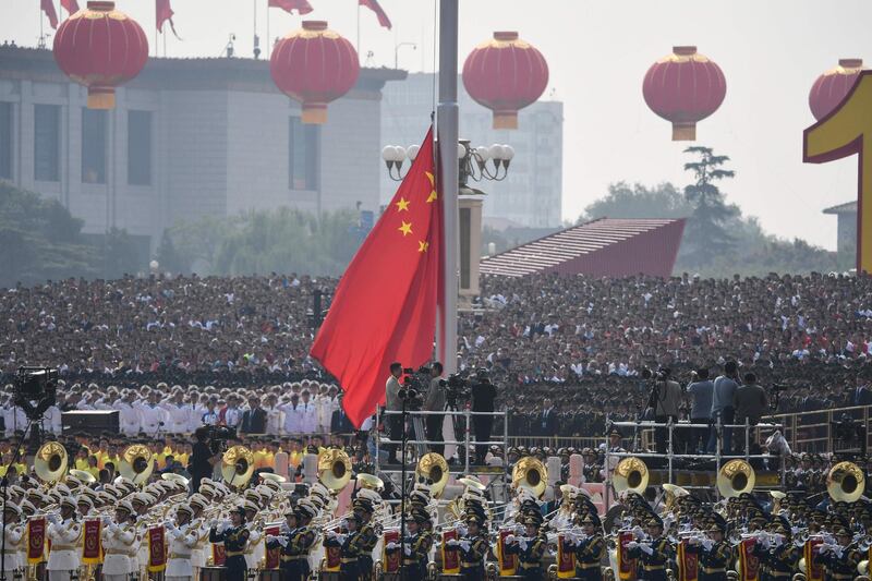 A Chinese national flag is raised. AFP