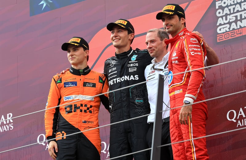 From left: Second placed McLaren driver Oscar Piastri, race winner Mercedes driver George Russell, and Ferrari driver Carlos Sainz Jr after the Austrian GP in Spielberg. EPA