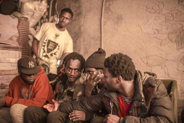 Sub-Saharan migrants sit in a tent they share at Ouled Ziane camp in Casablanca, Morocco. AP