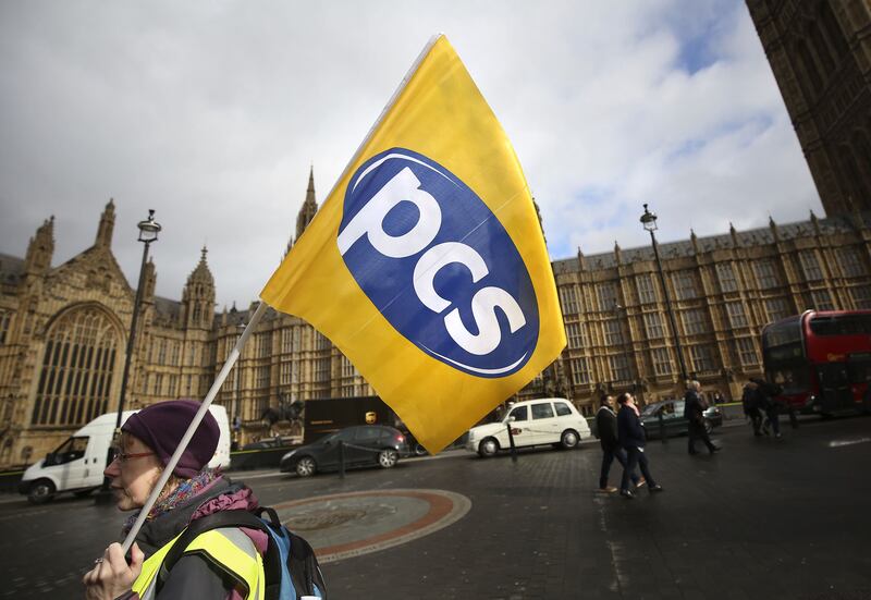 About 100,000 civil servants have voted for a national strike over pay, pensions and jobs. PA