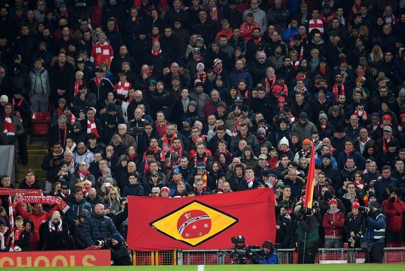 Liverpool fans hold a Brazilian style flag as they observe a minute’s silence for the victims of the plane crash involving the Brazilian club Chapecoense. Laurence Griffiths / Getty Images