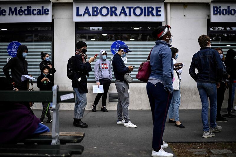 People wait to take a PCR test in Paris. AFP