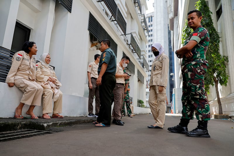 People gather outside Indonesia Defence Ministry buildings following the earthquake. Reuters