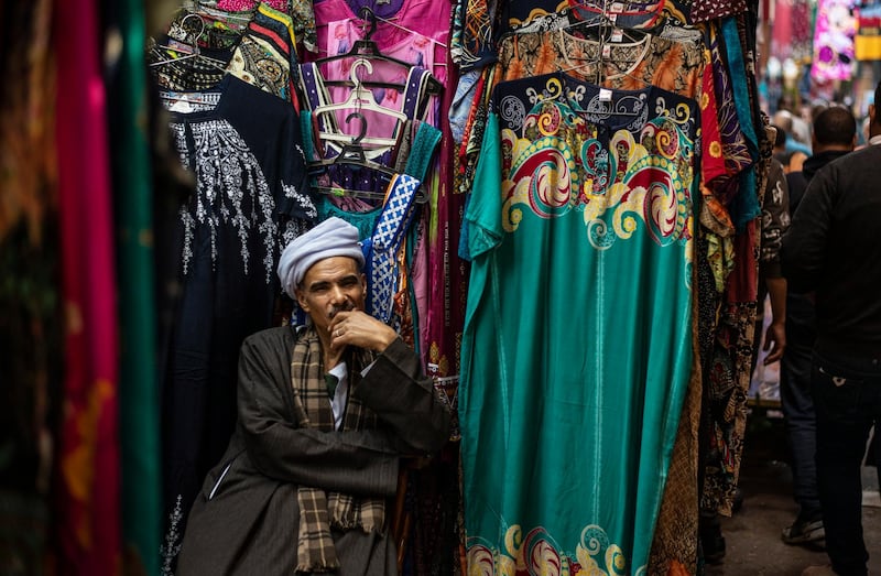 A vendor waits for customers as people shop at a market on the eve of the first day of Ramadan in Cairo. EPA