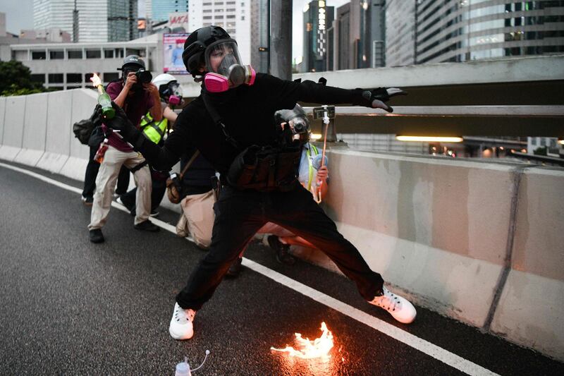 A protester throws a molotov cocktail towards police in the Admiralty area of Hong Kong.   AFP
