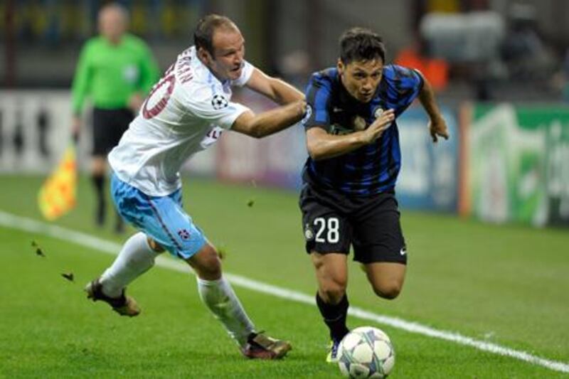 MILAN, ITALY - SEPTEMBER 14:  Mauro Zarate of FC Inter Milan and Serkan Balci (L) of Trabzonspor As in action during the UEFA Champions League group B match between FC Internazionale Milano and Trabzonspor As at Giuseppe Meazza Stadium on September 14, 2011 in Milan, Italy.  (Photo by Claudio Villa/Getty Images)
