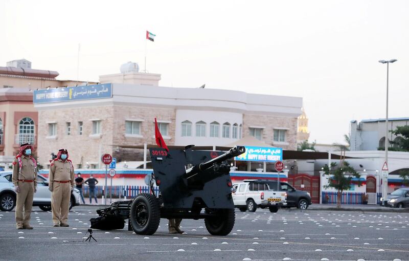 DUBAI, UNITED ARAB EMIRATES , April 24– 2020 :- Dubai Police officer ready to fire the cannon on the first day of Ramadan to break the fast at the Al Mankhool area in Dubai.  (Pawan Singh / The National) For News/Standalone/Online/Instagram. 