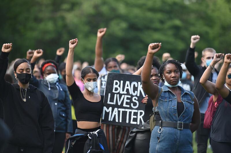 Protesters hold up fists at a gathering in support of the Black Lives Matter movement on Woodhouse Moor in Leeds in northern England, in the aftermath of the death of unarmed black man George Floyd in police custody in the US.   AFP