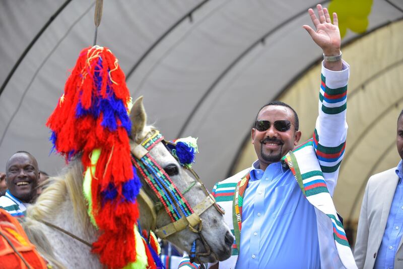 Ethiopian Prime Minister Abiy Ahmed gestures after receiving a horse as a gift from the elders of the Kafficho ethnic group during a visit to Bonga, the main town in Kaffa province, in south western Ethiopia on September 15, 2019. - Ethiopian Prime Minister Abiy Ahmed pleaded for patience during a visit on September 15, 2019, to leaders of the latest ethnic group pushing to form a breakaway region. The bid by the Kafficho ethnic group to form a new federal state risks further destabilising Ethiopia's diverse southern region, which just two months ago was rocked by violence stemming from a similar campaign by the Sidama ethnic group. Ethiopia is currently partitioned into nine semi-autonomous regions. The constitution requires the government to organise a referendum for any ethnic group that wants to form a new entity. (Photo by MICHAEL TEWELDE / AFP)