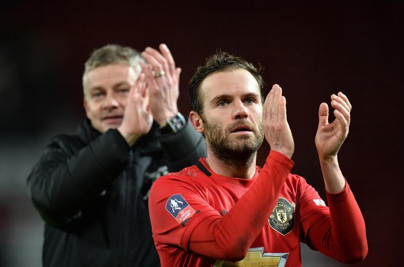 Manchester United manager Ole Gunnar Solskjaer and midfielder Juan Mata applaud fans at the end of the game. EPA