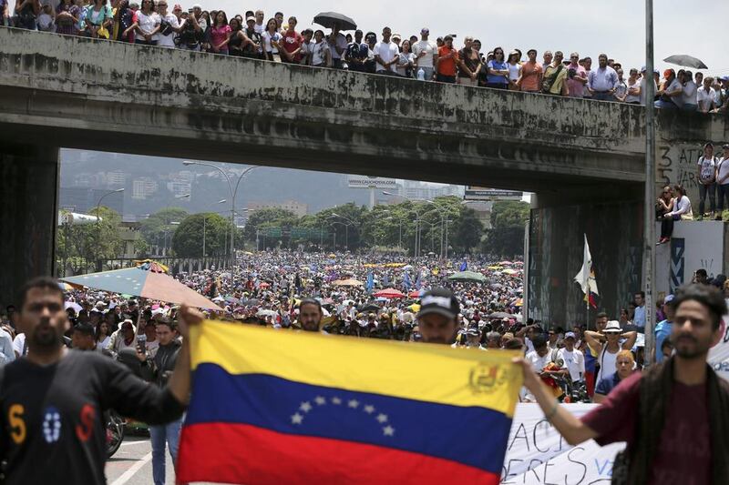 Anti-government protesters block a road in Caracas, Venezuela. Fernando Llano / AP Photo