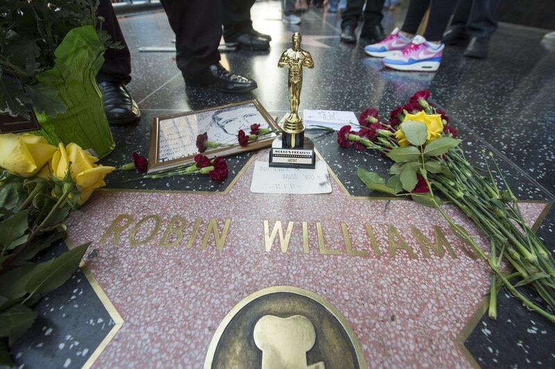 Flowers and momentos left by fans are seen at Robin Williams' star on the Hollywood Walk of Fame in Hollywood, California. Academy Award-winning actor and comedian Robin Williams was found dead in his Marin County home of an apparent suicide. He was 63 years old. Robyn Beck / AFP