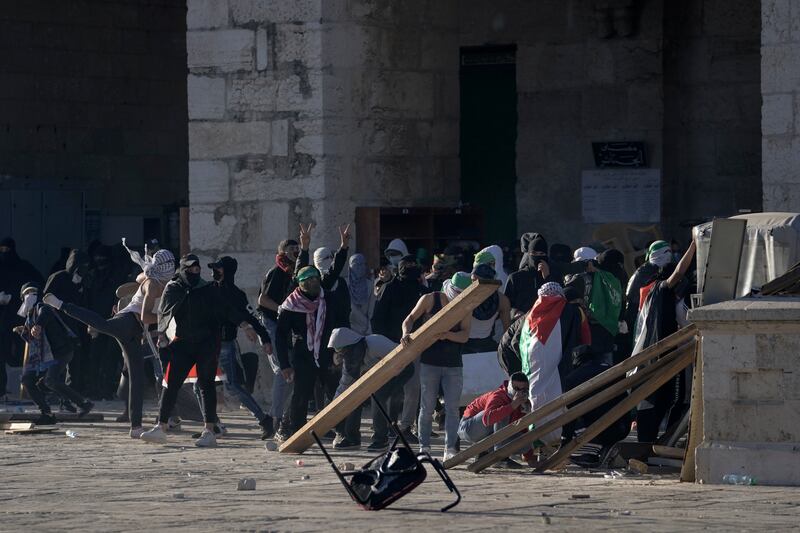 Worshippers set up barricades outside the mosque during the violence. AP