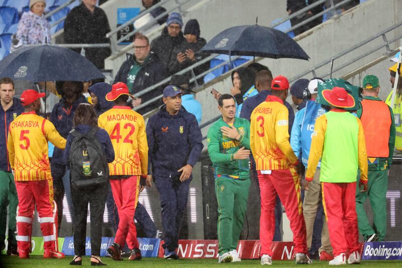 Zimbabwe and South African players shake hands after their T20 World Cup match in Hobart was called off due to rain. AFP