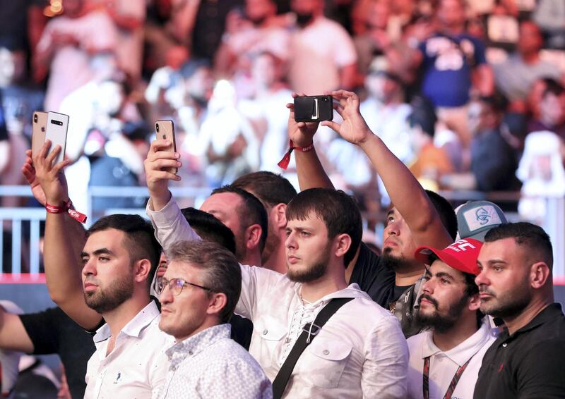 Abu Dhabi, United Arab Emirates - September 07, 2019: Fight fans take pics. Welterweight bout between Belal Muhammad and Takashi Satō in the Early Prelims at UFC 242. Saturday the 7th of September 2019. Yas Island, Abu Dhabi. Chris Whiteoak / The National