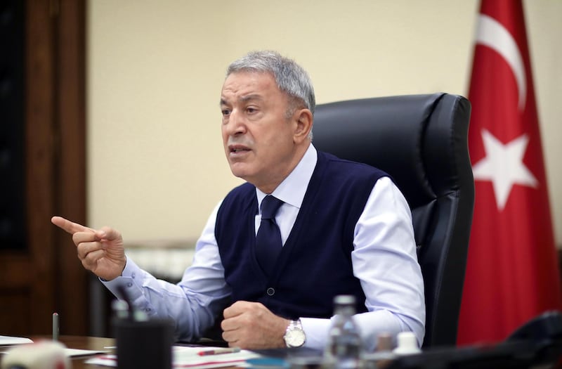 Turkish National Defense Minister Hulusi Akar speaks as he chairs a teleconference call meeting with Chief of General Staff General Yasar Guler, Deputy Ministers Yunus Emre Karaosmanoglu with Alpaslan Kavaklioglu at the Turkish National Defense Ministry Building in Ankara on October 05, 2020. (Photo by Adem ALTAN / POOL / AFP)