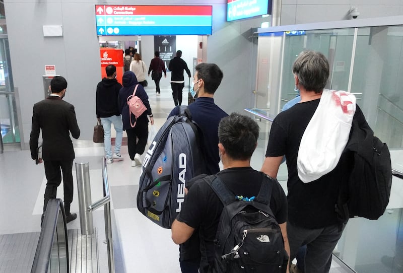 Novak Djokovic walks through Dubai International Airport after landing from Melbourne where he was deported on Sunday. Reuters