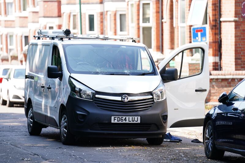 A white van behind a police cordon on the corner of Maples Street and Bentinck Road in Nottingham. PA
