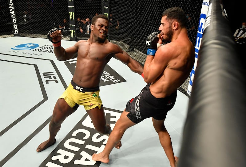 Abdul Razak Alhassan (left) of Ghana punches Mounir Lazzez of Tunisia in their welterweight fight during the UFC Fight Night event inside Flash Forum on UFC Fight Island in Yas Island, Abu Dhabi.