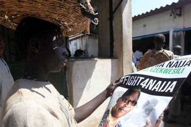 A trader looks at a poster of ACPN female presidential candidate Oby Ezekwesili in Kaduna on January 17, 2019. AFP