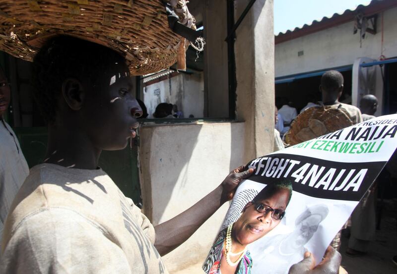 A trader looks at a poster of ACPN (Allied Congress Party of Nigeria) female presidential candidate Oby Ezekwesili in Kaduna on January 17, 2019. Oby Ezekwesili, a former Minister of Education and co-founder of the NGO Transparency International, has become a figure in the #BringBackOurGirls movement, created in support of more than 200 high school girls from Chibok, kidnapped by Boko Haram in 2014. / AFP / Sodiq Adelakun
