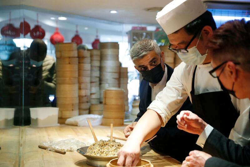 Mayor of London Sadiq Khan, third right, with head chef Ling Bing during a visit to Dumplings Legend in Chinatown, central London. AP Photo