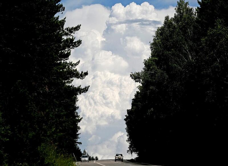 Cars drive along the “Yenisei” M54 federal motorway, with heavy clouds seen in the sky, through the Siberian Taiga area outside Krasnoyarsk, Russia. Reuters