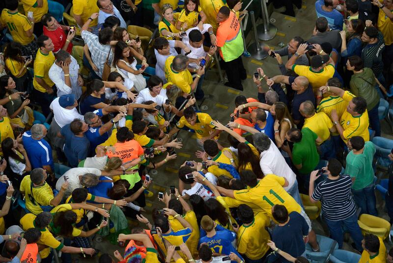 this handout image provided by FIFA Neymar of Brazil is congratulated by fans at the end of the FIFA Confederations Cup Brazil 2013 Final match between Brazil and Spain at Maracana on June 30, 2013 in Rio de Janeiro, Brazil.    AFP PHOTO / POOL FIFA ALEXANDRE LOUREIRO - RESTRICTED TO EDITORIAL USE
 *** Local Caption ***  464513-01-08.jpg